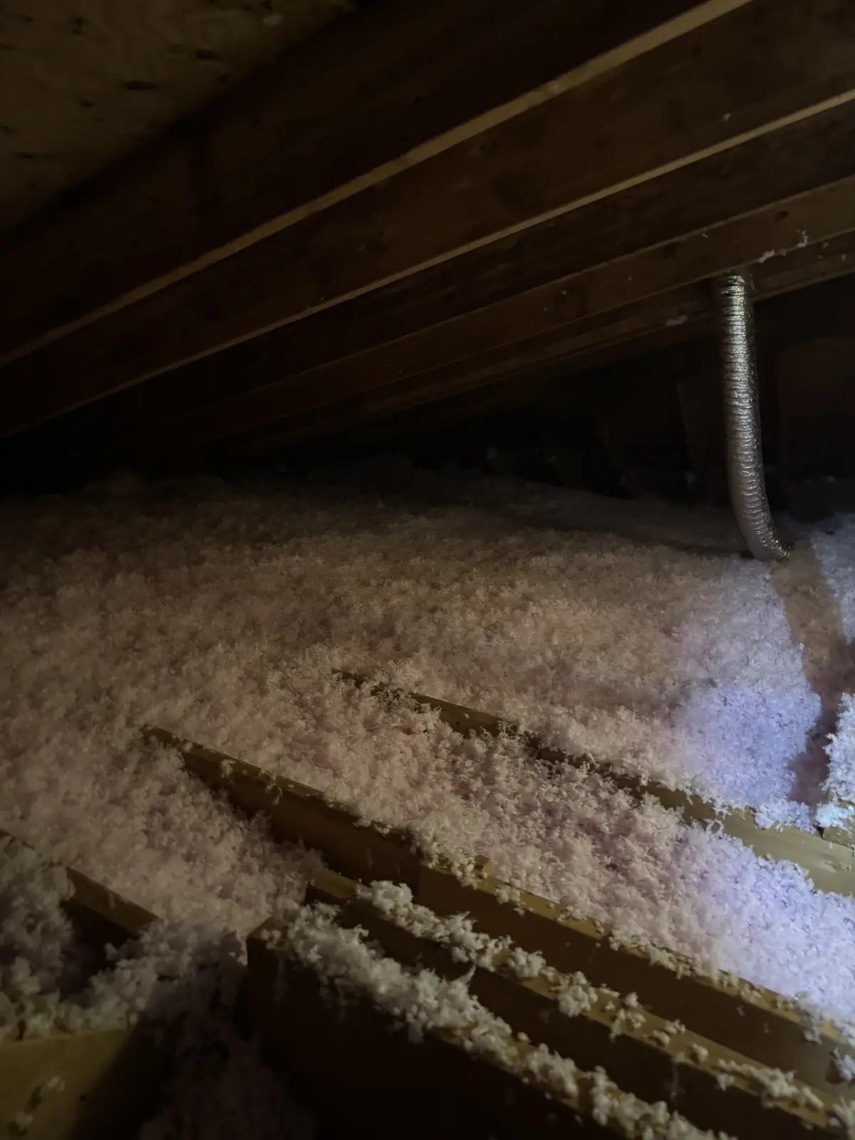 A fresh layer of blown-in insulation reaching toward the eaves